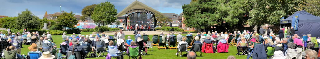 A view of the Performance Pavilion and residents enjoying an afternoon music on the Recreation Ground