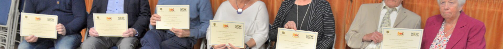 7 residents holding their Citizen of the Year certificates