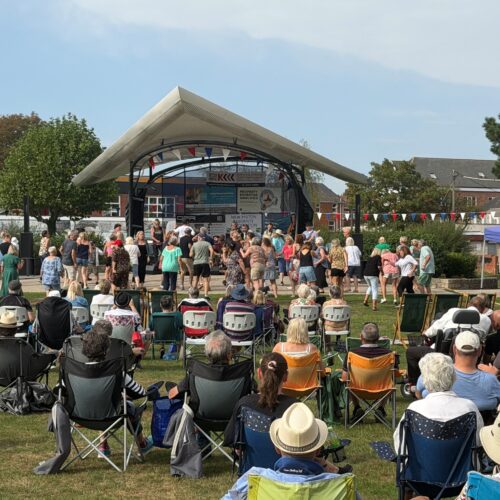 Crowds of people enjoying afternoon of live music